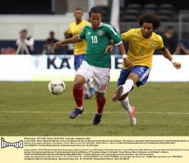 3 June 2012 - Brazil defender Marcelo Vieira ( 6) passes the ball as Mexico forward Giovani dos Santos ( 10) closes in during the International Soccer friendly between Brazil and Mexico at Cowboys Stadium in Arlington, Texas. Mexico won 2-0. SOCCER: JUN 03 Brazil v Mexico Icon12060312 EDITORIAL USE ONLY