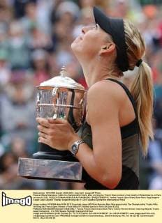 Russian Maria Sharapova holds the championship trophy after winning her French Open women s final match at Roland Garros in Paris on June 9, 2012.  PAR20120609710