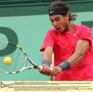 Spaniard Rafael Nadal hits a shot during his French Open men s final match at Roland Garros in Paris on June 10, 2012.  PAR20120610703