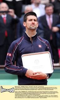 Novak Djokovic of Serbia poses for photos with the trophy during the awarding ceremony for men s singles at the French Open tennis tournament in Paris - 