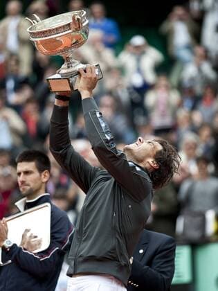 June 11, 2012 Rafael Nadal of Spain raises the French Open Men s Champions trophy after Nadal win the final of the French Open, played at Stade Roland Garros, Paris - Icon2501206116385 EDITORIAL USE ONLY