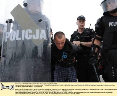 The police detain a Polish fan in central Warsaw.  RE100F00