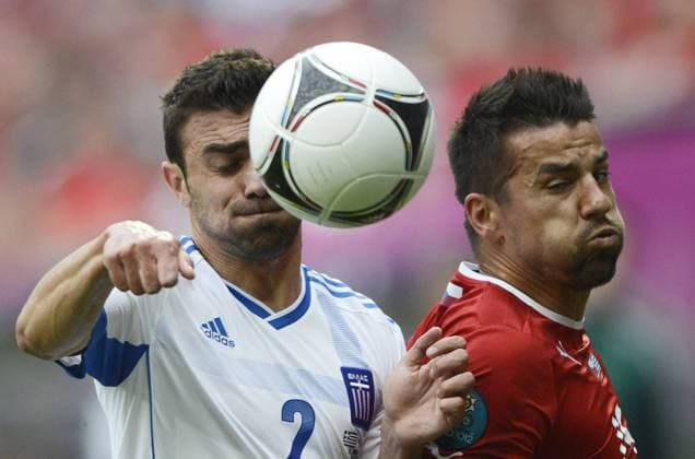 Milan Baros (R) of Czech Republic vies with Giannis Maniatis of Greece during the Group A 2nd round match at the Euro 2012 football championships in Wroclaw, Poland, June 12, 2012. (Xinhua Wu Wei) (kh) POLAND-WROCLAW-EURO 2012 FOOTBALL CHAMPIONSHIPS-GREECE VS CZECH 
