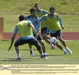 EURO 2012 - POLAND - Gniewino - 13 JUNE 2012 - Spain National Team official MD-1 training. Spanish players Cesc Fabregas and Sergio Busquets fighting the ball. 