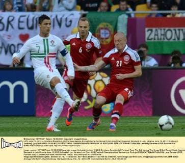 LVIV, June 13, 2012 -- Cristiano Ronaldo (L) of Portugal passes the ball during the Group B 2nd round match against Denmark in Lviv, Ukraine, June 13, 2012. (Xinhua Li Jundong) (jyc) UKRAINE-LVIV-EURO 2012 FOOTBALL CHAMPIONSHIPS-DENMARK VS PORTUGAL 
