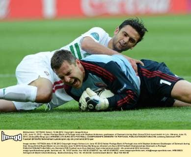 LVIV, June 13, 2012 -- Helder Postiga (Back) of Portugal vies with Stephan Andersen, goalkeeper of Denmark during their Group B 2nd round match in Lviv, Ukraine, June 13, 2012. (Xinhua Ma Ning) (jyc) UKRAINE-LVIV-EURO 2012 FOOTBALL CHAMPIONSHIPS-DENMARK VS PORTUGAL 