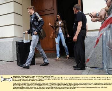 WARSAW, POLAND. JUNE 17, 2012. Russia s forward Roman Pavlyuchenko (L) with wife Larisa leave the Bristol Hotel. Russia failed to reach the Euro 2012 quaterfinal after losing 0-1 in a Group Stage match against Greece.  RE101580