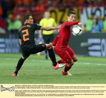 Portugals Cristiano Ronaldo tussles with Gregory van der Wiel of the Netherlands..Euro 2012 Portugal v Netherlands, Metalist Stadium, Kharkiv, 17th June 2012. Pic David Klein SPORTIMAGE... EDITORIAL USE ONLY. No use with unauthorised audio, video, data, fixture lists, club league logos or live services. Online in-match use limited to 120 images, no video emulation. No use in betting, games or single club league player publications.