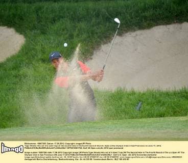 Tiger Woods hits out of a sand trap on the second hole in the fourth round of the U.S. Open at the Olympic Club in San Francisco on June 17, 2012.  SFP2012061704