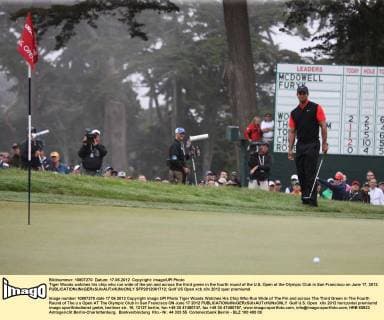 Tiger Woods watches his chip who run wide of the pin and across the third green in the fourth round of the U.S. Open at the Olympic Club in San Francisco on June 17, 2012.  SFP2012061712