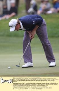 Webb Simpson leans down to check his ball on the edge of the cup on the fourth hole in the final round of the U.S. Open at the Olympic Club in San Francisco on June 17, 2012. Simpson won by a stroke at one over par with a combined score of 281.  SFP2012061734