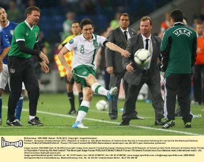 Football - European Championships 2012 - Republic of Ireland vs. Italy Keith Andrews of Ireland kicks the ball in frustration following his red card at the Municipal Stadium, Poznan 