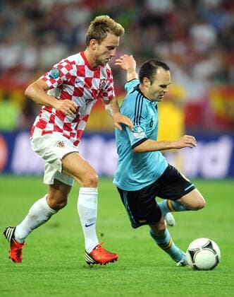 ITAR-TASS: GDANSK, POLAND. JUNE 18, 2012. Croatiaâ€™s Ivan Rakitic (L) and Spainâ€™s Andres Iniesta fight for the ball in their Euro 2012 Group C football match at PGE Arena Gdansk. Spain won the game 1:0.  RE101717