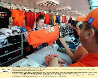 ITAR-TASS: DONETSK, UKRAINE. JUNE 19, 2012. Official fan shop with UEFA EURO 2012 souvenirs in the fanzone (fan zone).  RE101669