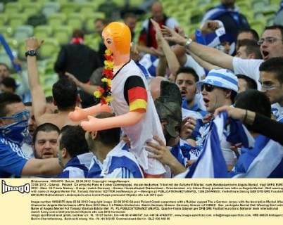 22.06.2012 - Gdansk , Poland . Griechische Fans mit einer Gummipuppe, die ein deutsches Trikot mit der Aufschrift Merkel, nach Bundeskanzlerin Angela Merkel, trägt UEFA EURO 2012 . Mecz 1 4 Finalu Niemcy - Grecja match Germany - Greece fussballspiell Deutschland - Griechenland . n z. kibice Grecji przebrali sex lalke za Angela Merkel . Doll wearing shirt with name of Angela Merkel Fot. Tomasz Wantula EDYTOR.net Newspix.pl --- Newspix.pl  120622WAN003