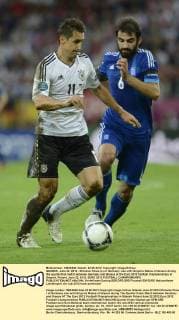 GDANSK, June 22, 2012 - Miroslav Klose (L) of Germany vies with Grigoris Makos of Greece during the quarterfinal match between Germany and Greece at the Euro 2012 football championships in Gdansk, Poland, June 22, 2012. EURO 2012 FOOTBALL CHAMPIONSHIPS 