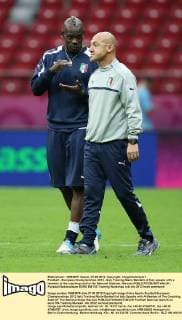 Football - European Championships 2012 - Italy Training Mario Balotelli of Italy speaks with a member of the coaching staff at the National Stadium, Warsaw 
