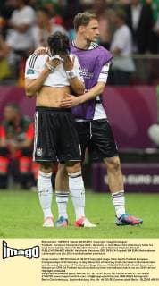 Football - European Championships 2012 - Germany vs. Italy Mesut Özil of Germany holds his head in his hands - here with Benedikt Höwedes - at the National Stadium, Warsaw 