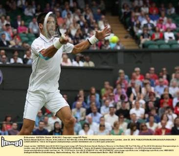 Serbian Novak Djokovic returns in his match on the fifth day of the 2012 Wimbledon championships in London, June 29, 2012.  LON2012062914
