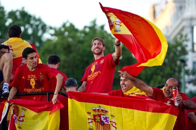 Sergio Ramos (C) and Jesus Navas (L) - Spanish national football team have bathed in the crowd that was waiting for them to go through Madrid s streets on an open bus to celebrate their winning EURO 2012. RobertoxMariscal 