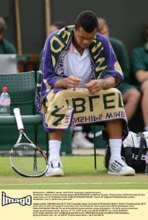 Wimbledon Week 2; Tennis Championships 2012 03 07 2012 Jo Wilfried Tsonga - France plays with the threads at have come loose on his Wimbledon towel 