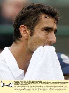 LONDON, July 3, 2012 -- Marin Cilic of Croatia reacts during the fourth round match of men s singles at the Wimbledon Championships 2012 in London, Britain on July 3, 2012. 