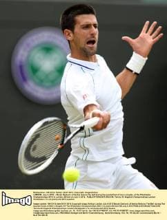 LONDON, July 4, 2012 -- Novak Djokovic of Serbia returns the ball during the quarterfinal of men s singles at the Wimbledon Championships 2012 in London, Britain on July 4, 2012. 