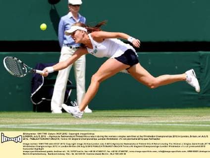 LONDON, July 5, 2012 -- Agnieszka Radwanska of Poland hits a return during the women s singles semifinal at the Wimbledon Championships 2012 in London, Britain, on July 5, 2012. 