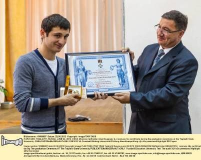 ITAR-TASS: TOGLIATTI, RUSSIA. JUNE 22, 2012. CSKA Moscow midfielder Alan Dzagoyev (L) receives his certificate during the graduation ceremony at the Togliatti State University.  RE101C1A