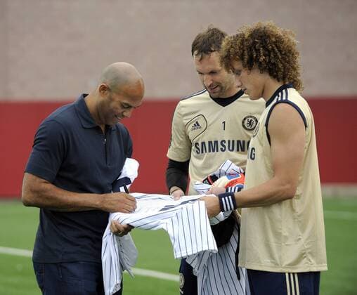 July 21 2012: New York Yankees pitcher Mariano Rivera autographs a jersey for Chelsea FC s Petr Cech 1 and David Luiz 4 during media interviews at the Chelsea FC training session at the Timex Performance Center in East Rutherford, New Jersey. Soccer 2012: Chelsea FC Training Session JUL 21 - ZUMAcw2