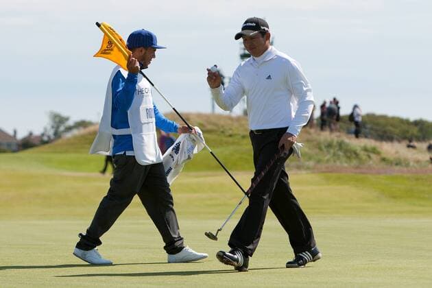 Golf - The Open - Day Four Carlos Tevez of Manchester City acts as caddie for Andres Romero of Argentina at Royal Lytham & St Anne s Golf Club 