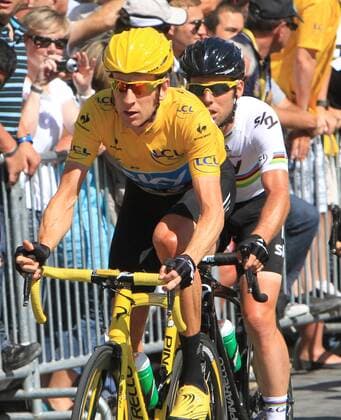 Bradley Wiggins (yellow jersey) rides along the Champs-Elysees en route to winning his first Tour de France title in Paris on July 22, 2012. Wiggins became Britain s first ever winner of the Tour de France.  PAR20120722703