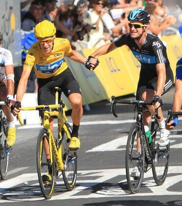 Bradley Wiggins (yellow jersey) celebrates with a teammate after crossing the finish line along the Champs-Elysees during the Tour de France in Paris on July 22, 2012. Wiggins became Britain s first ever winner of the Tour de France.  PAR20120722721