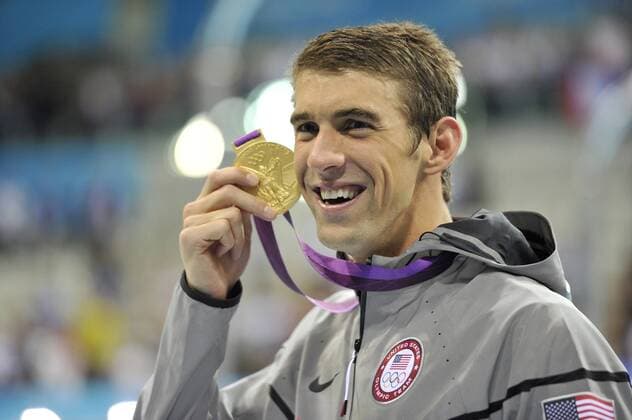 Michael Phelps of the United States holds his Gold Medal for the Men s 4 X 200M Freestyle Relay Final after the medal ceremony at the London 2012 Summer Olympics on July 31, 2012 in Stratford, London. The United States team won Gold with a time of 6:59.70 in the relay.  OLY20120731463