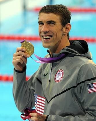 July 25, 2012 - London, GBR - USA s Michael Phelps shows off his gold medal in the men s 4x200-meter freestyle relay, Tuesday, July 31, 2012, during the Summer Olympic Games in London, England. Men s 4x200-meter Freestyle Relay - ZUMAm67