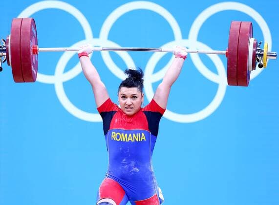 (120801) -- LONDON, Aug. 1, 2012 (Xinhua) -- Roxana Daniela Cocos of Romania competes during the women s 69kg weightlifting event at London 2012 Olympic Games, London, Britain, Aug. 1, 2012. Roxana Daniela Cocos won the silver medal of the event with a total of 256kg. (Xinhua Chen Jianli) (OLY2012)BRITAIN-LONDON-WEIGHTLIFTING-WOMEN-69KG 