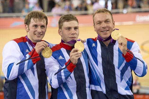 02.08.2012 Stratford, London, England. L-R goldmedalists Jason Kenny (GBR), Philip Hindes (GBR) and Chris Hoy (GBR) from Great Britain collect their medals on the podium for the Mens Team Sprint Final on day 6 of the London 2012 Olympic Games at the Velodrome in the Olympic Park. xRoganxThomsonx  ActionPlus11310880