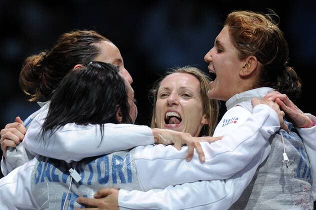 LONDON, AUGUST 3, 2012. Gold medal winners, Italy s Ilaria Salvatori, Elisa Di Francisca, Valentina Vezzali, and Arianna Errigo (from L, clockwise) celebrate their team s victory over the Russian team in the women s team foil goldmedal bout during the 2012 London Summer Olympic Games.  RE104BA0