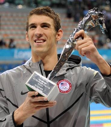 Michael Phelps (USA) holds a special Olympic recognition trophy after he won his 18th gold in the Men s 4x100 Medley Relay Final at the Aquatics Center during the London 2012 Summer Olympics in Stratford, London on August 4, 2012. Phelps won his record 18th gold and 22nd Olympic Medals to end his Olympic career.  OLY201208041255