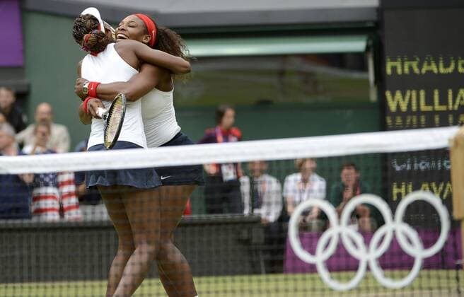 Venus (L) and Serena Williams of the United States (USA) celebrate the Women s Doubles Gold Medal tennis match at the London 2012 Summer Olympics on August 5, 2012 in Wimbledon, London.  OLY20120805444