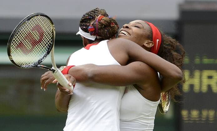 Venus (L) and Serena Williams of the United States (USA) celebrate the Women s Doubles Gold Medal tennis match at the London 2012 Summer Olympics on August 5, 2012 in Wimbledon, London.  OLY20120805443