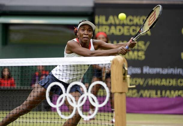 Venus Williams of the United States returns as shot during the Women s Doubles Gold Medal tennis match at the London 2012 Summer Olympics on August 5, 2012 in Wimbledon, London.  OLY20120805453