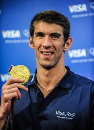 US swimmer Michael Phelps shows one of his Goldmedals at a press conference during the London 2012 Olympic Games in London, UK, 5 August 2012. Flashing a lop-sided smile of satisfaction and relief, Michael Phelps left the Olympic arena for the final time on Saturday after finishing his competitive career with a scarcely credible 18 Goldmedals. Michael Phelps quits the pool with unchallenged record  20120806_40001