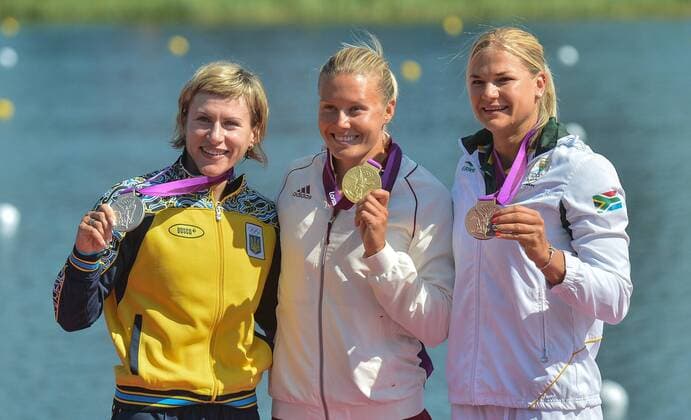 Gold medalist Danuta Kozak of Hungary (C), silver medalist Inna Osypenko-Radomska of Ukraine (L) and bronze medalist Bridgitte Hartley of South Africa attend victory ceremony of women s kayak single (k1) 500m competition of Canoe Sprint event, at London 2012 Olympic Games in London, Britain, on August 9, 2012. (Xinhua Cheng Min) (nxl) (OLY2012)BRITAIN-LONDON-CANOE SPRINT-WOMEN S KAYAK SINGLE (K1) 500M 