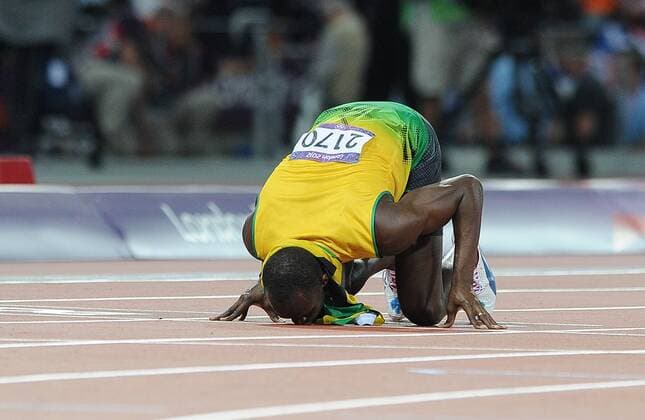 Olympics - London 2012 - Athletics Usain Bolt (JAM) celebrates winning the Mens 200m at the Olympic Stadium, London 