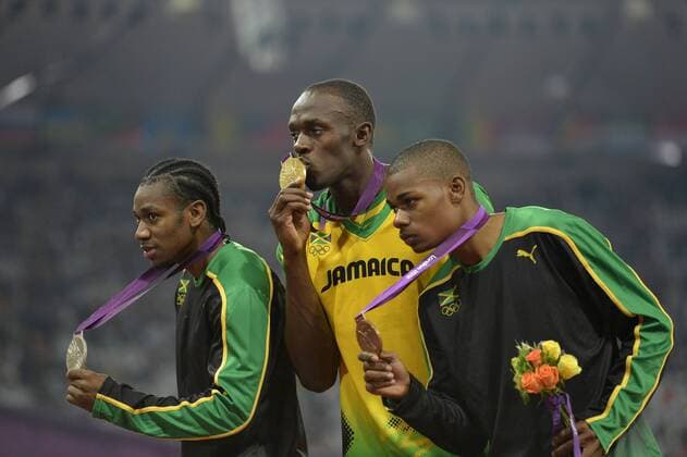 Silver Medalist Yohan Blake (L-R), Gold Medalist Usain Bolt and Bronze Medalist Warren Weir, all of Jamaica, pose with their medals during the victory ceremony for the Men s 200M Final at the London 2012 Summer Olympics on August 9, 2012 in Stratford, London. Bolt won Gold with a time of 19.32 seconds while Blake finished right behind at 19.44 and Weir finished at 19.84 in the final.  OLY20120809445
