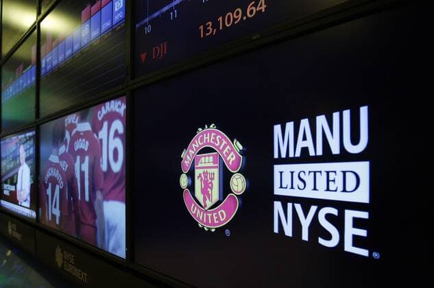 The team logo for Manchester United appears on a large monitor at the New York Stock Exchange on the morning that Manchester United Lists its Initial Public Offering at the NYSE on Wall Street In New York City on August 10, 2012. Manchester United will begin trading today on the NYSE under the ticker symbol MANU.  NYP20120810103