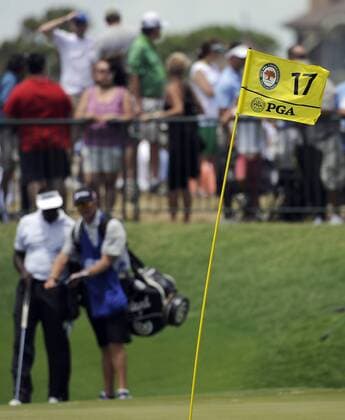 A stiff ocean breeze bends the pin flag on hole 17 while Vijay Singh of Fiji checks his yardage book during the second round of the PGA Golf Herren Championship on August 10, 2012 at the Ocean Course in Kiawah Island, South, Carolina.  SCP20120810119