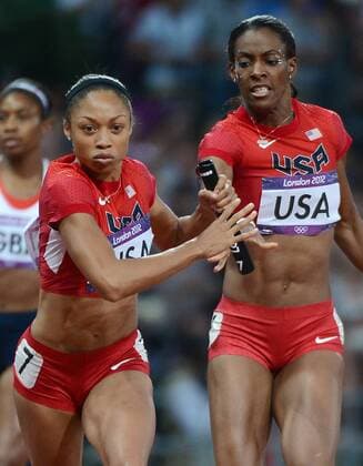 Aug. 11, 2012 - London, GBR - The USA s Allyson Felix, left, takes the baton from teammate DeeDee Trotter as she runs the second leg of the women s 4x400m relay at Olympic Stadium during the 2012 Summer Olympic Games in London, England, Saturday, August 11, 2012. 2012 Summer Olympics women s 4x400m relay - ZUMAm67