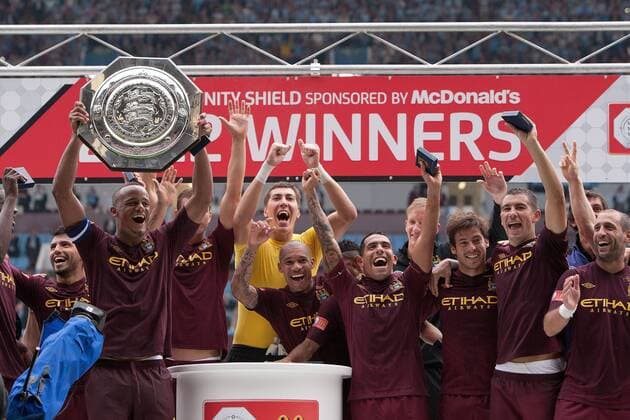 Football - FA Community Shield - Chelsea FC London vs. Manchester City; Manchester City, led by captain Vincent Kompany celebrate with the shield at Villa Park 
